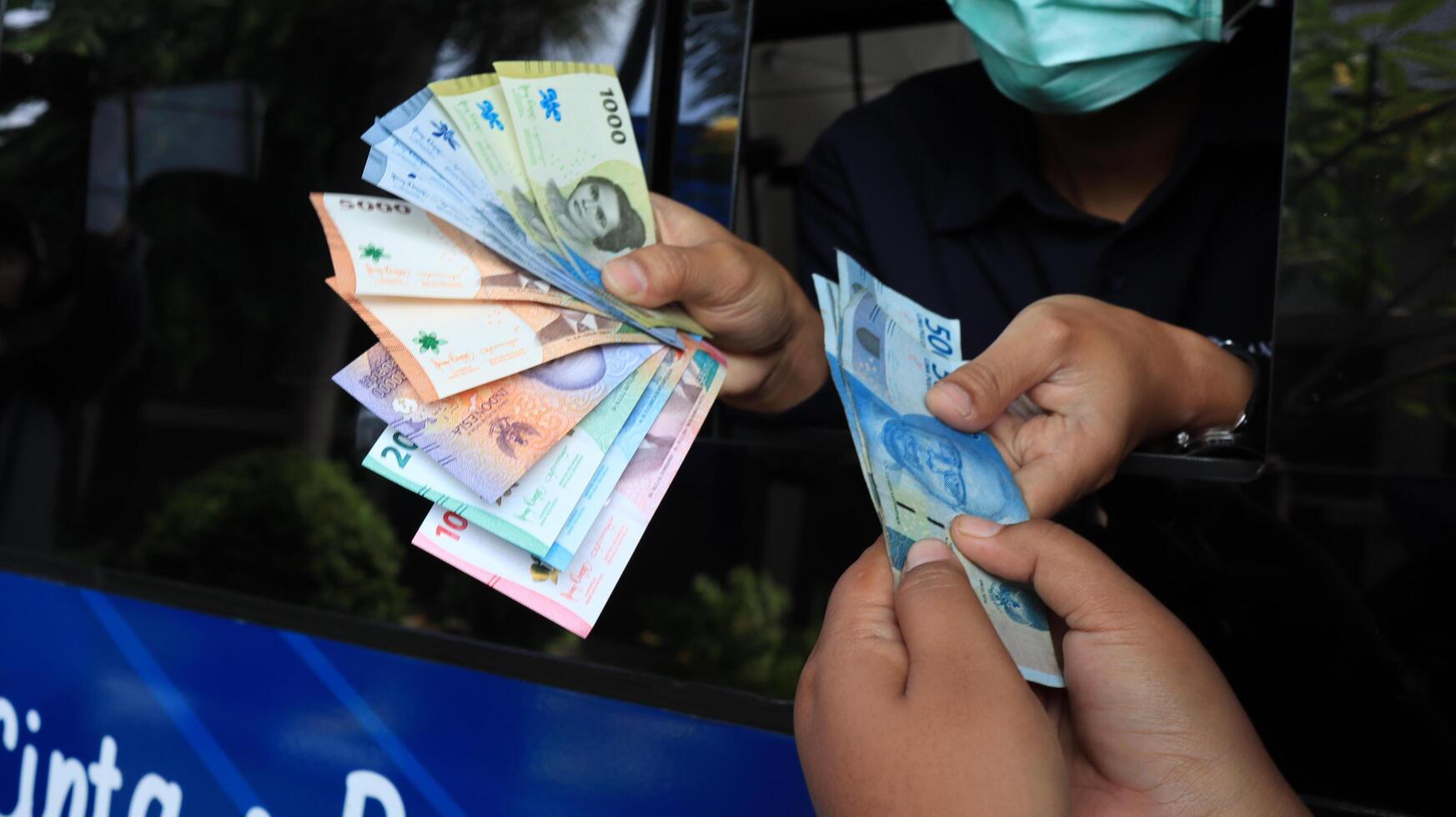 Residents queue to exchange new rupiah banknotes at Bank Indonesia services photo