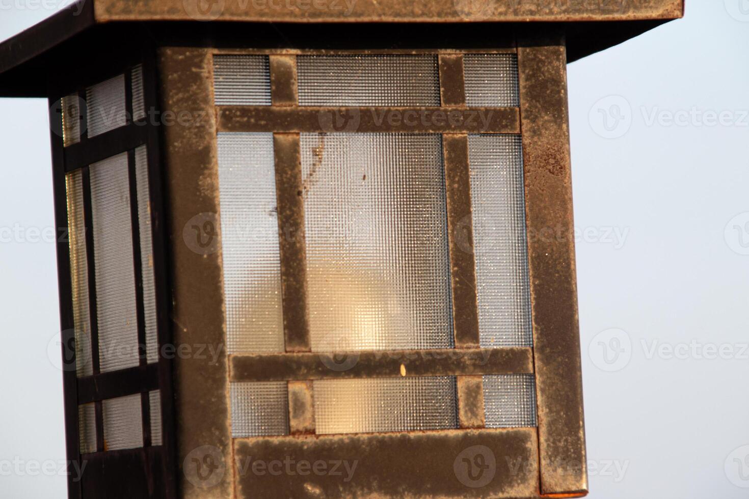 Old and antique street lamp isolated on blurred background photo