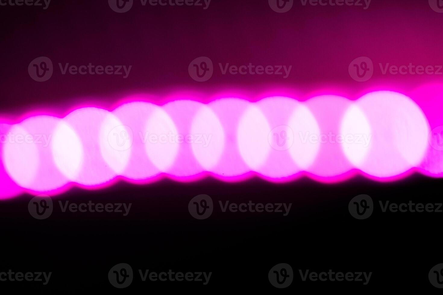 Blurred lights with purple bokeh effect Background photo
