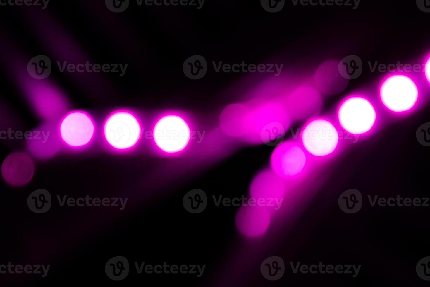 Blurred lights with purple bokeh effect Background photo