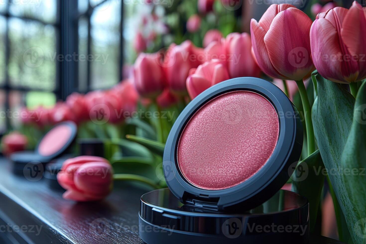 Soft blush compacts in peach tones, with a blurred field of tulips behind. Professional shot showcasing the delicate color and smooth texture of the blush. photo