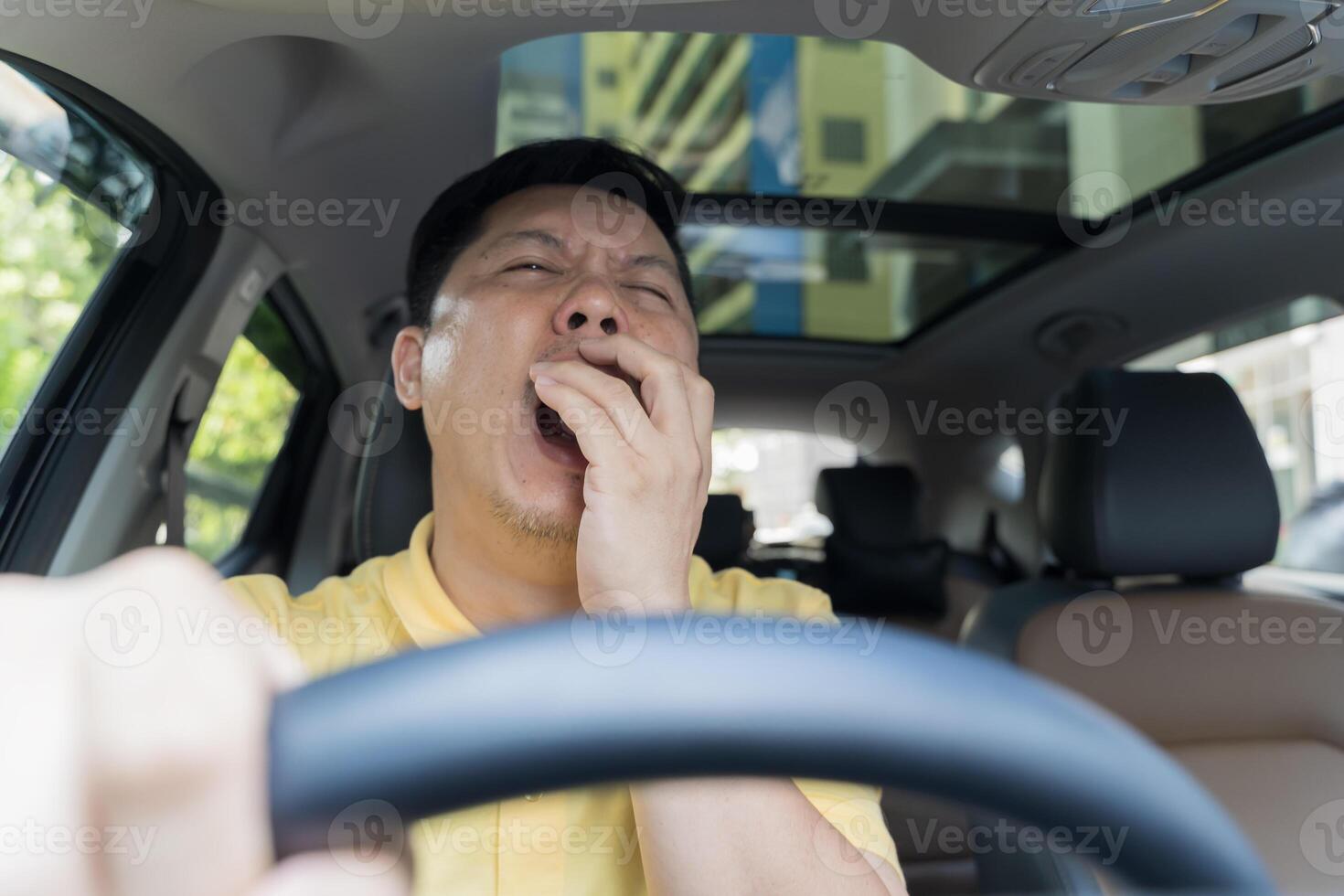 Tired man in car. Sleepy drowsy driver, fatigue. Driving and sleeping in vehicle. Exhausted, bored or drunk person. photo