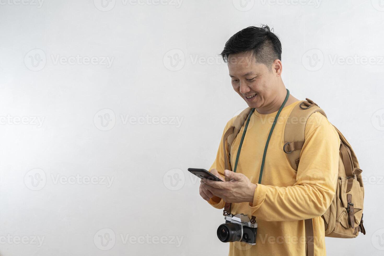 Happy traveler in summer dress using mobile phone typing sms message making winner gesture isolated on gray background . photo