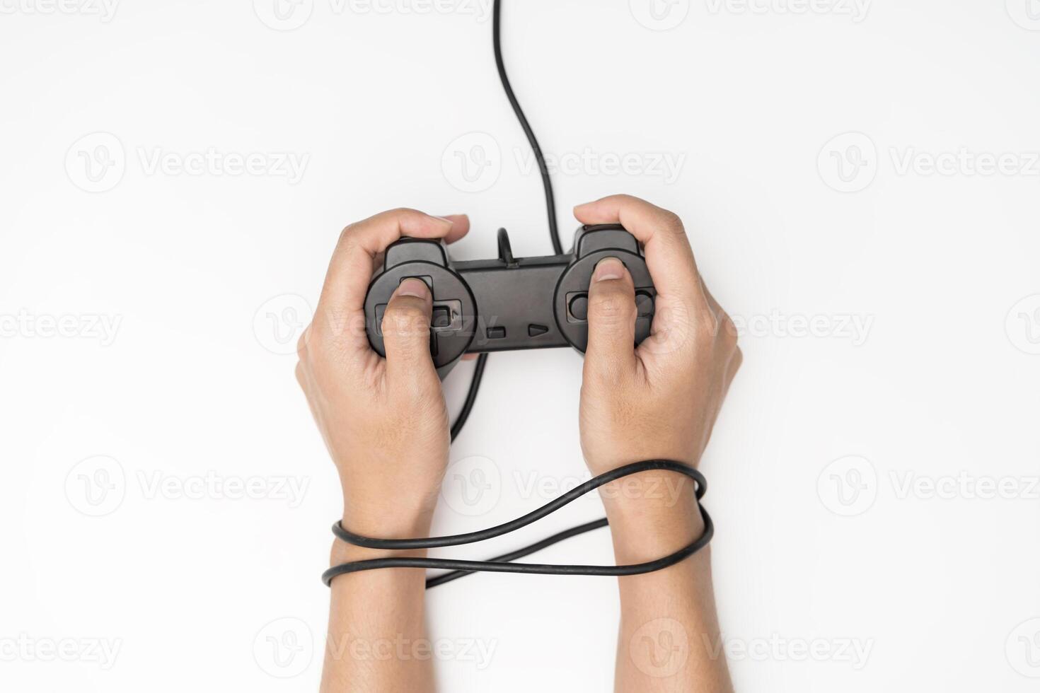 Game Addiction. Wire and gamepad or joystick, wired hands with joypad meaning photo