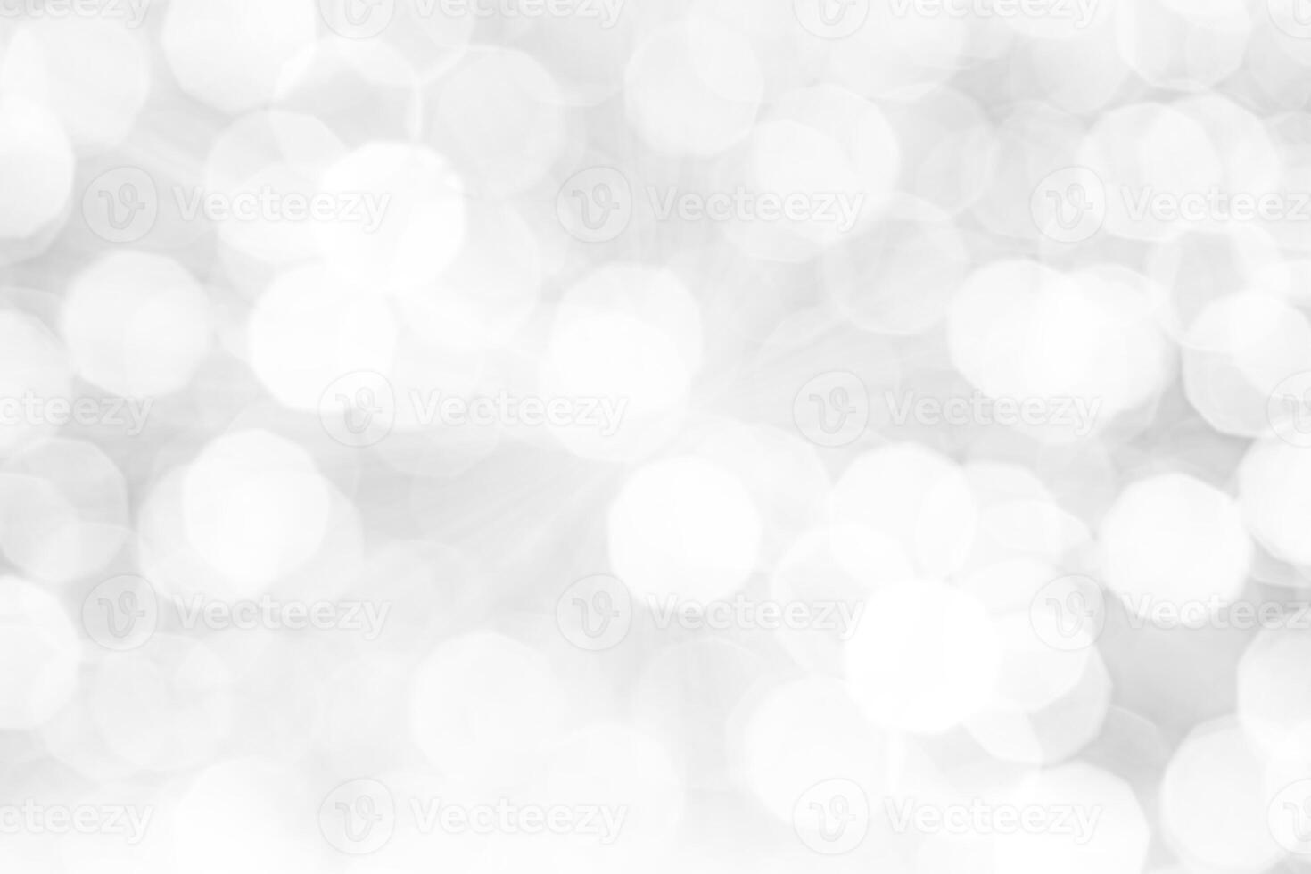 Blurred abstract background. Abstract white and silver blurred background with glittering lights for display. photo