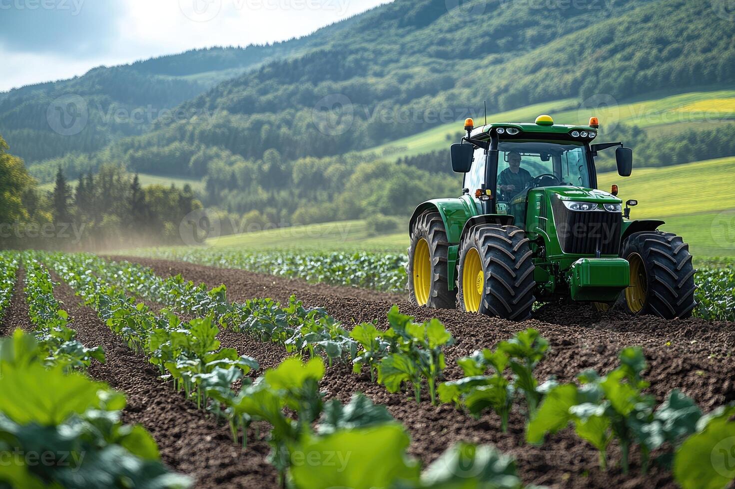 Farmer driving modern tractor plowing red dirt field for sowing photo