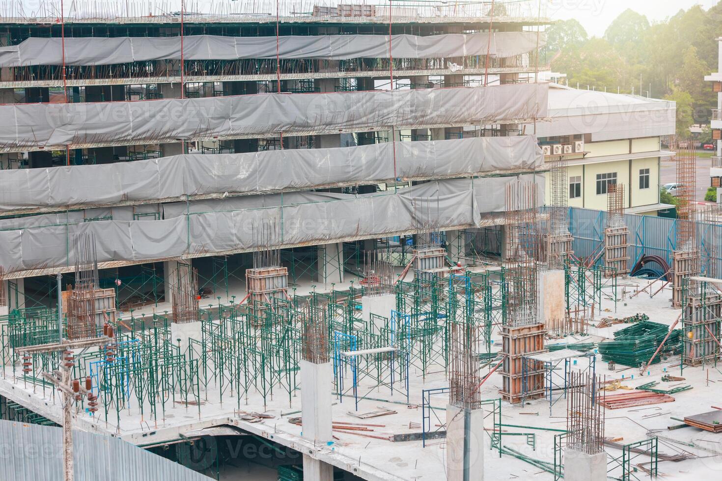 Tower cranes at construction site on sky background. Multi Storey Residential Buildings construction. Tower crane on Housing renovation. tower crane is attached to boom load secured with steel cables. photo