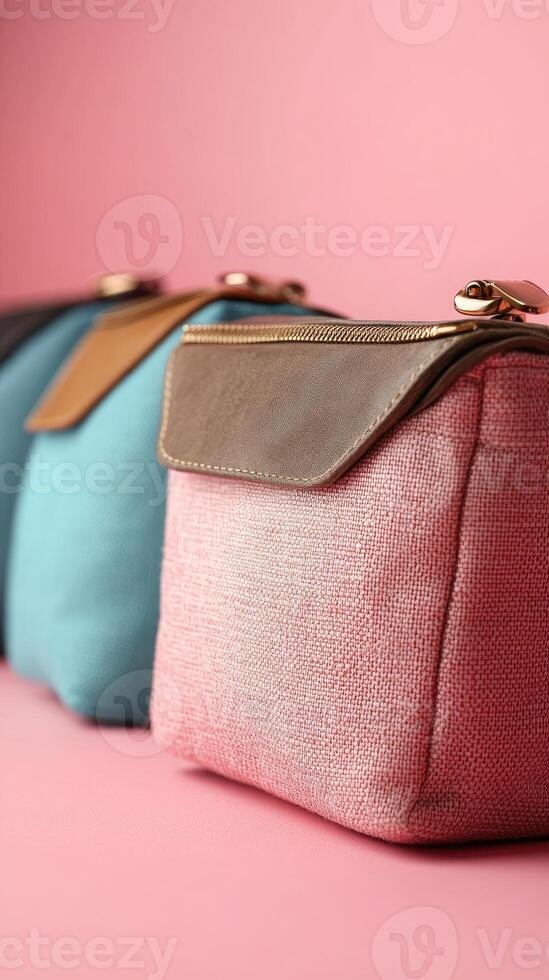 Several colorful cosmetic bags standing in a row on a table photo