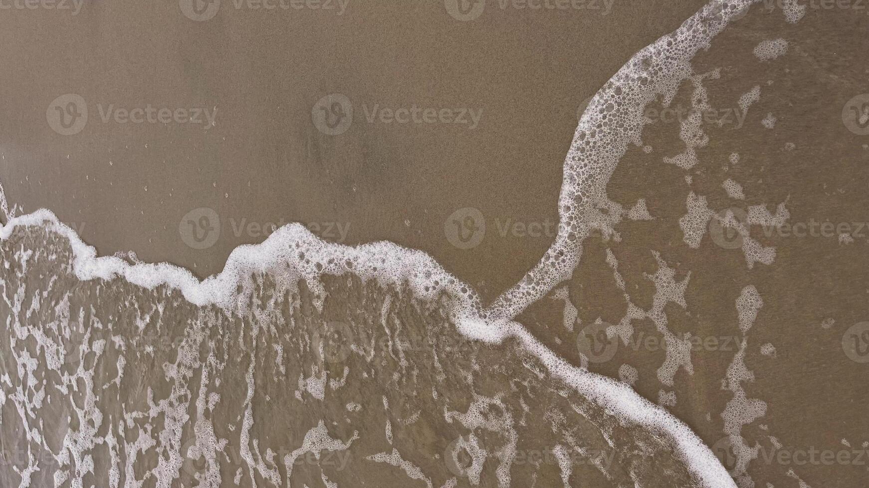 Waves rolling onto a sandy shore. Copy space photo