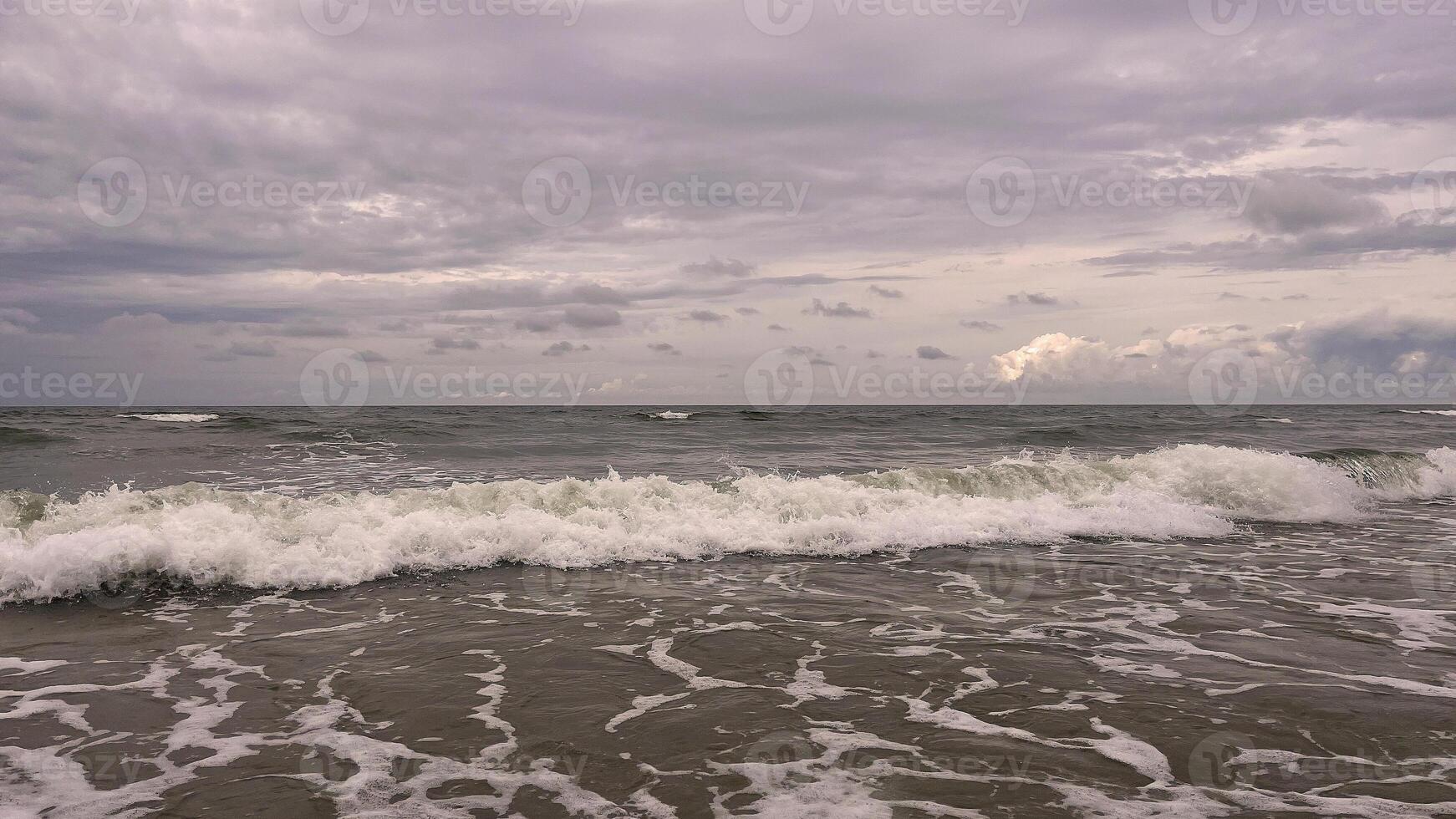 Seascape, stormy day on the Baltic Sea. Clouds meet the sea. photo
