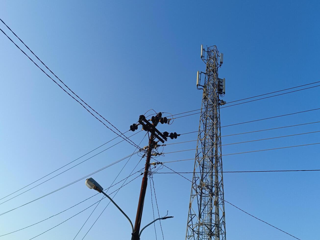 Power electric pole with line wire for residential buildings with blue sky background photo