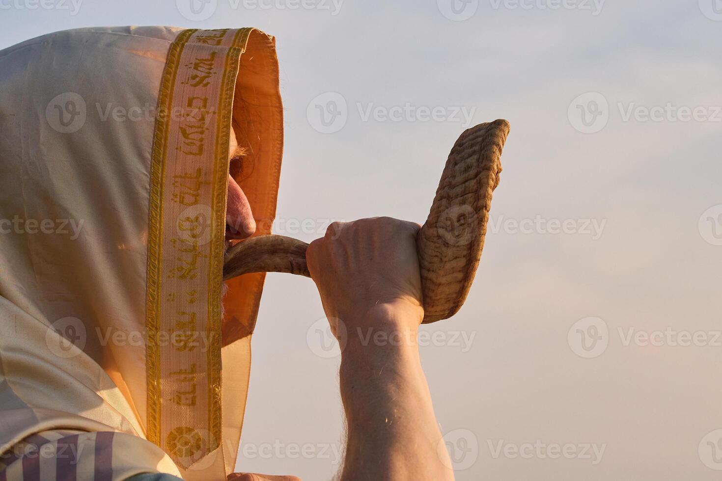Jewish man blowing the Shofar rams horn on Rosh Hashanah and Yom Kippur day. photo
