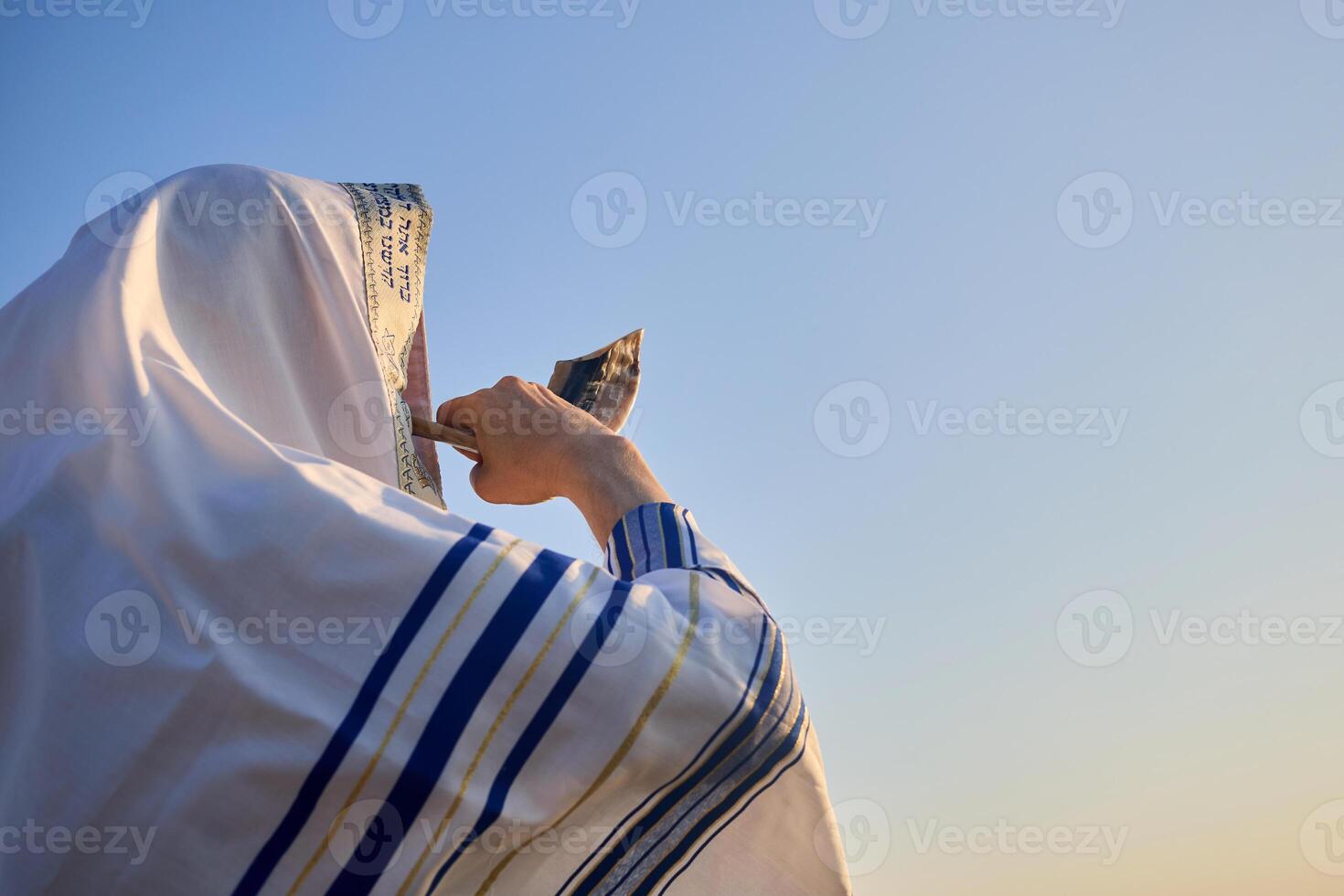 Jewish man blowing the Shofar rams horn on Rosh Hashanah and Yom Kippur day. photo