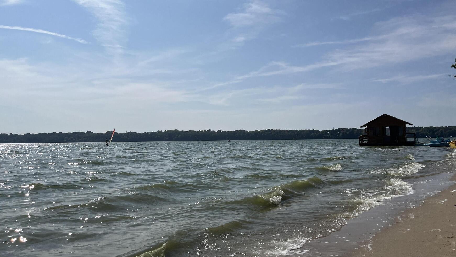 Nature photo of beach with small floating house and small boat. Text copy space for banners, cards.