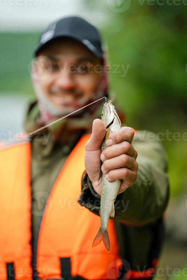 Fisherman shows a close-up of a fish photo