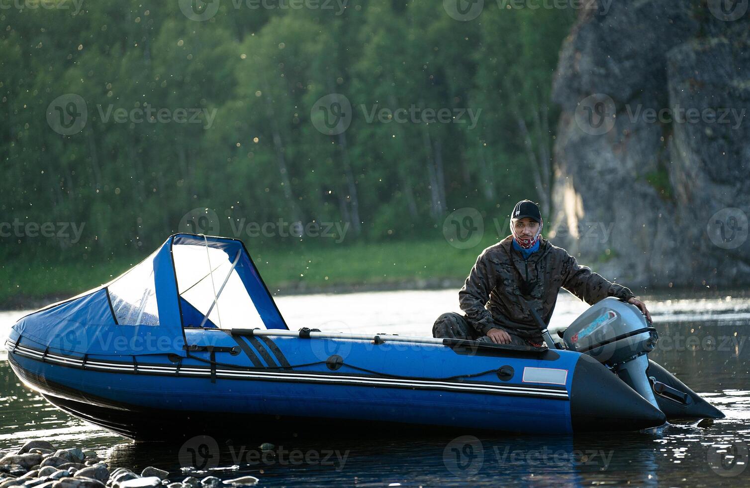 Fisherman on a boat with small mosquitoes in the background photo