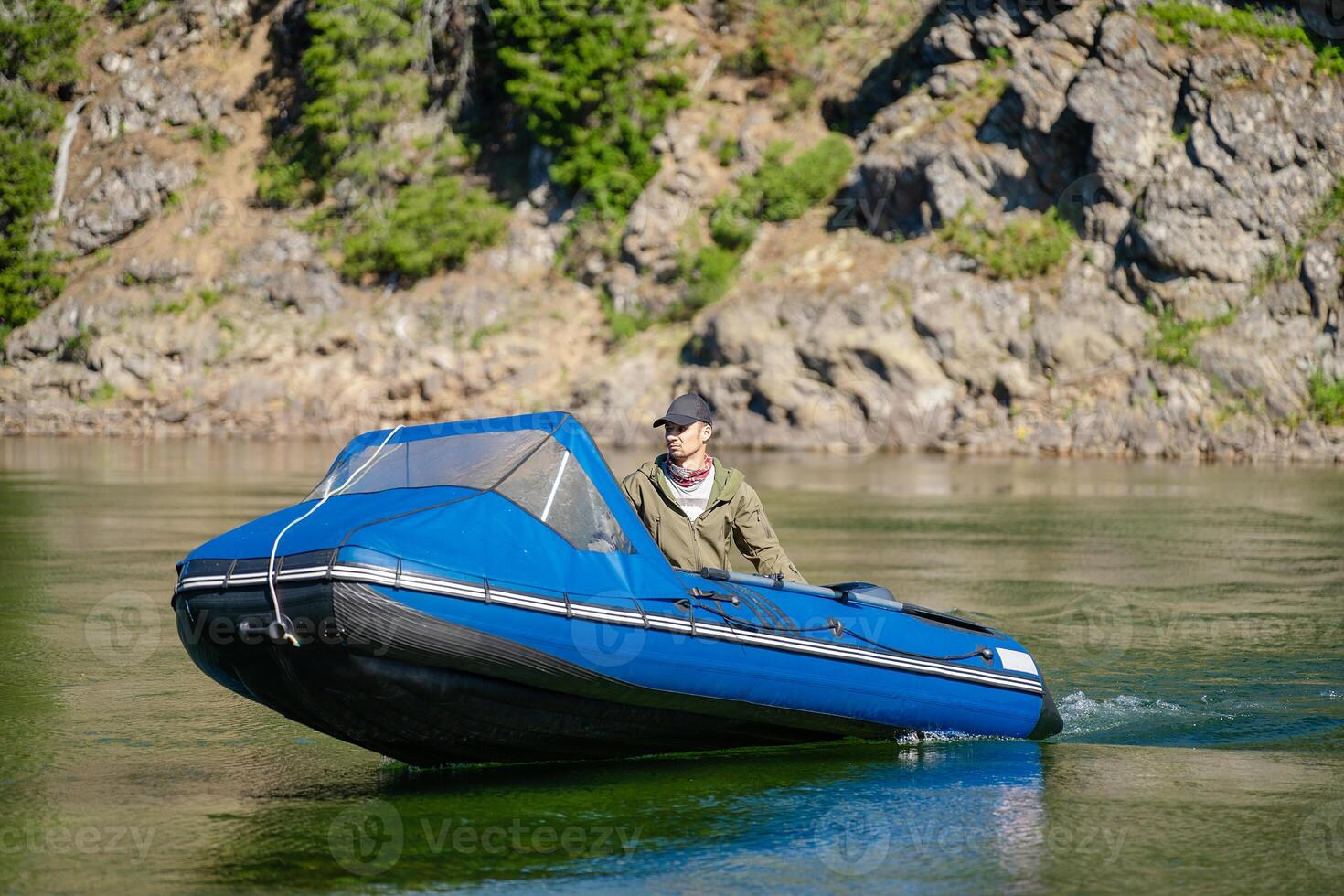 A fisherman is sailing in a boat along the river photo
