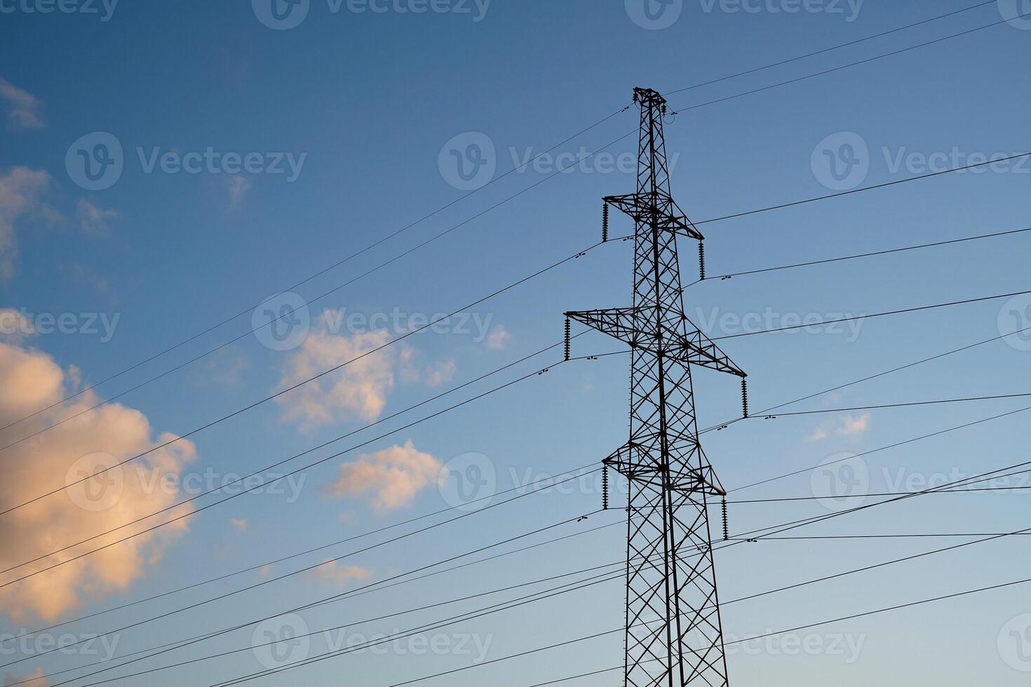 Power lines with wires on blue sky with clouds photo
