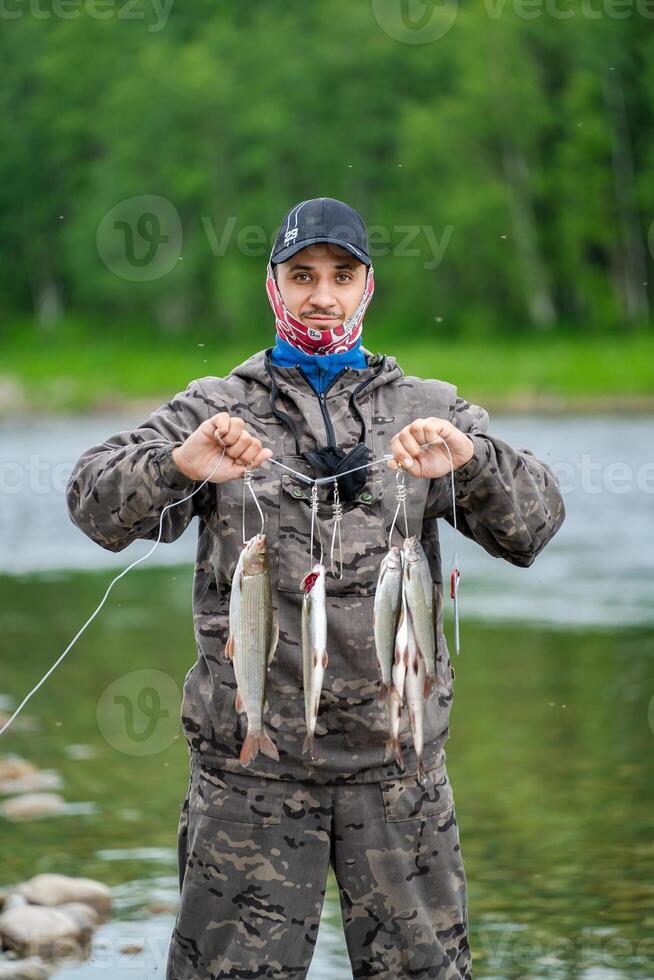 A fisherman shows his catch in a fish trap photo