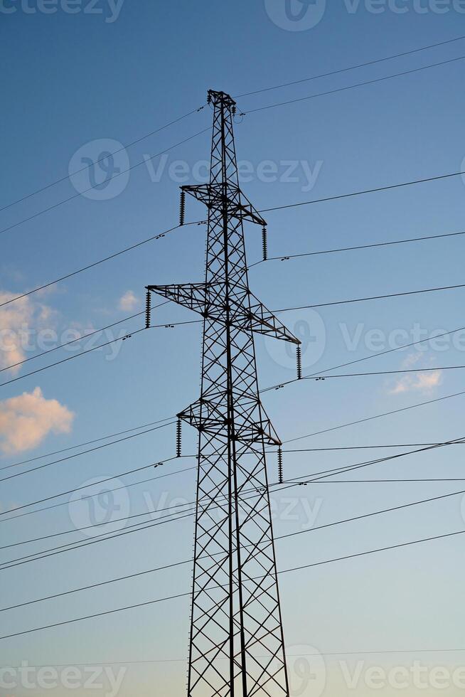 Power lines with wires on blue sky with clouds photo