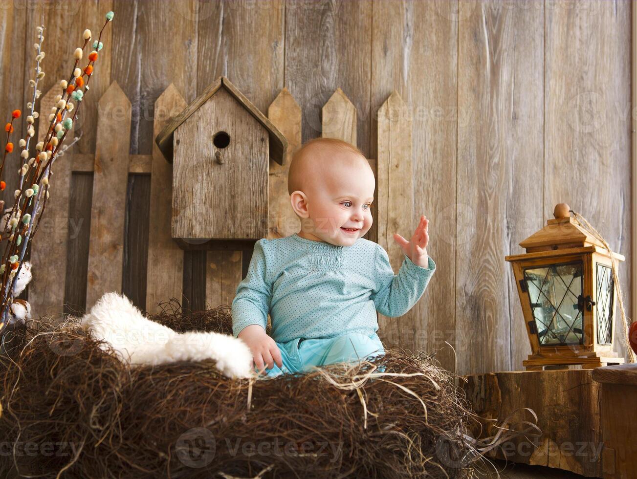 Portrait of an adorable baby girl near the wooden background photo