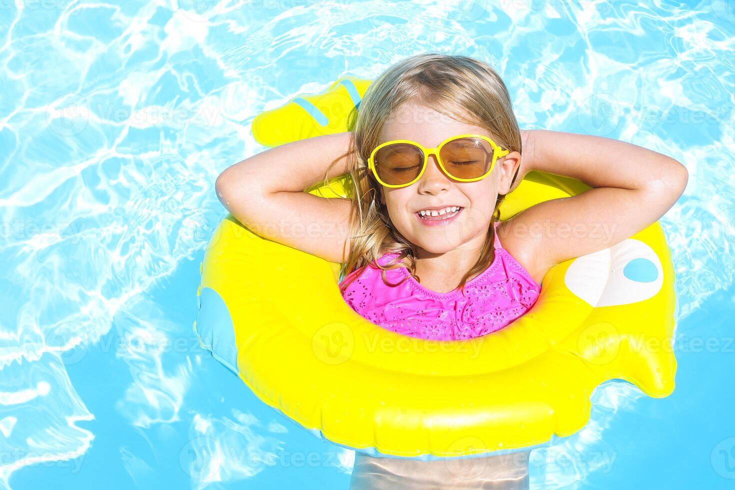 Happy child in swimming pool. Summer vacation photo