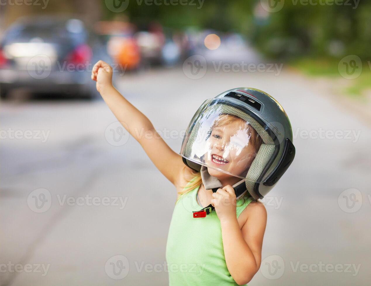 Happy kid playing in helmet outdoors photo
