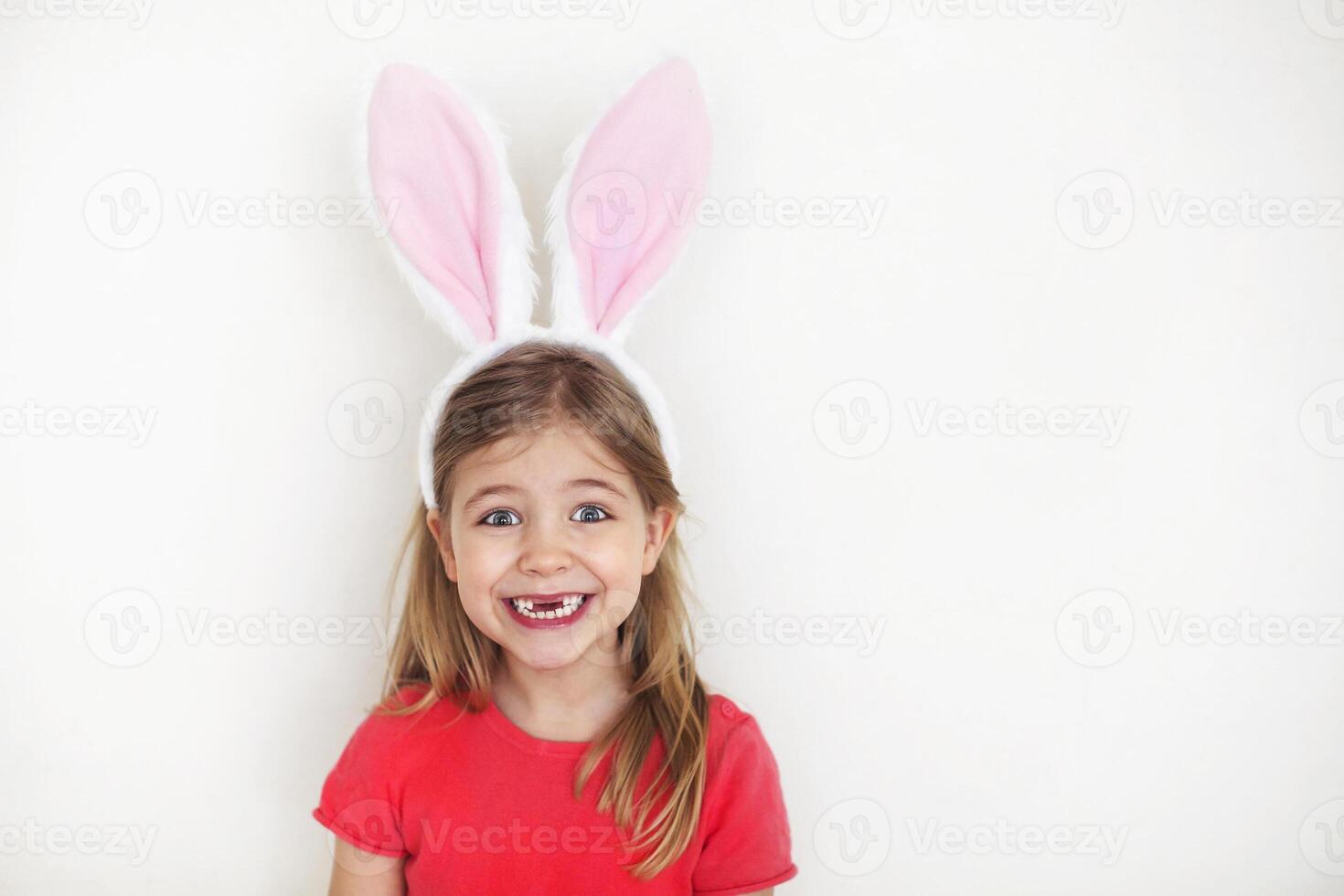 Happy little girl wearing funny bunny ears photo