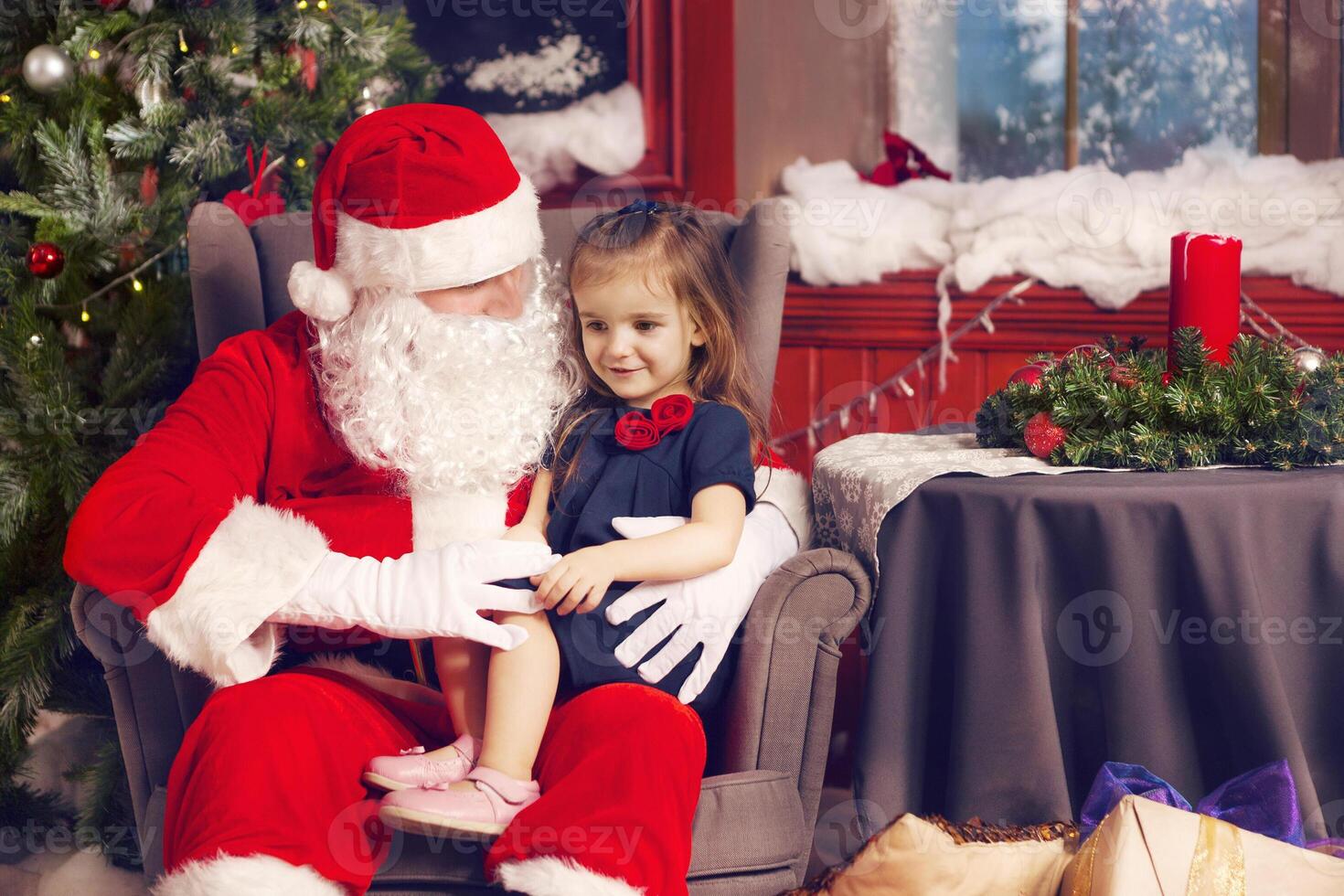 Little girl telling her Christmas wish in Santa Claus photo