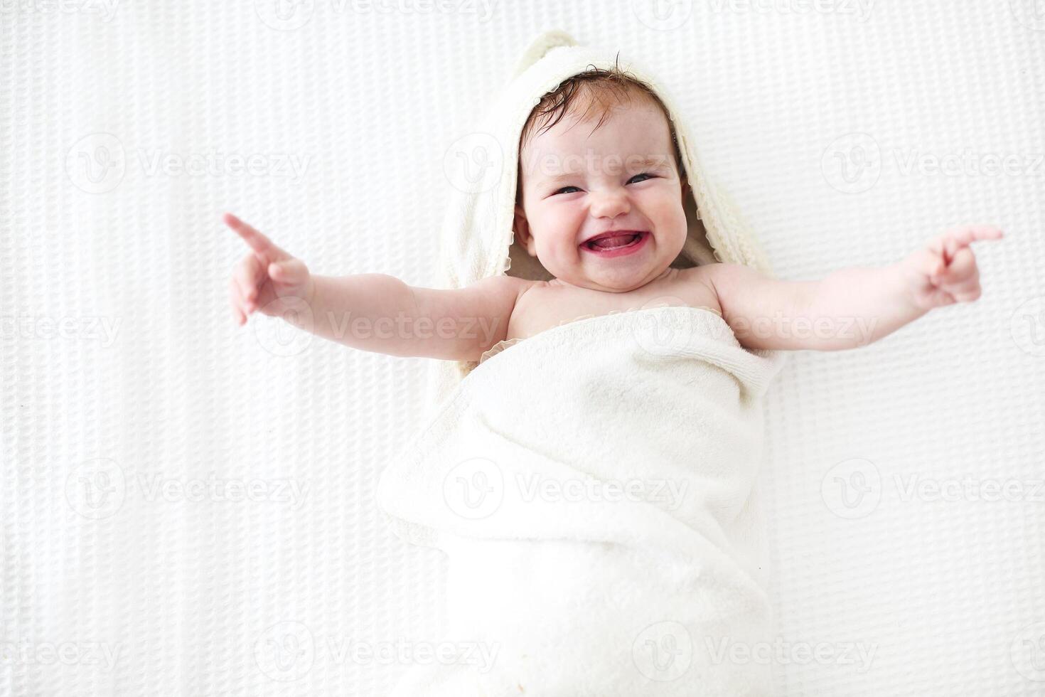 Six month baby wearing towel after bath photo