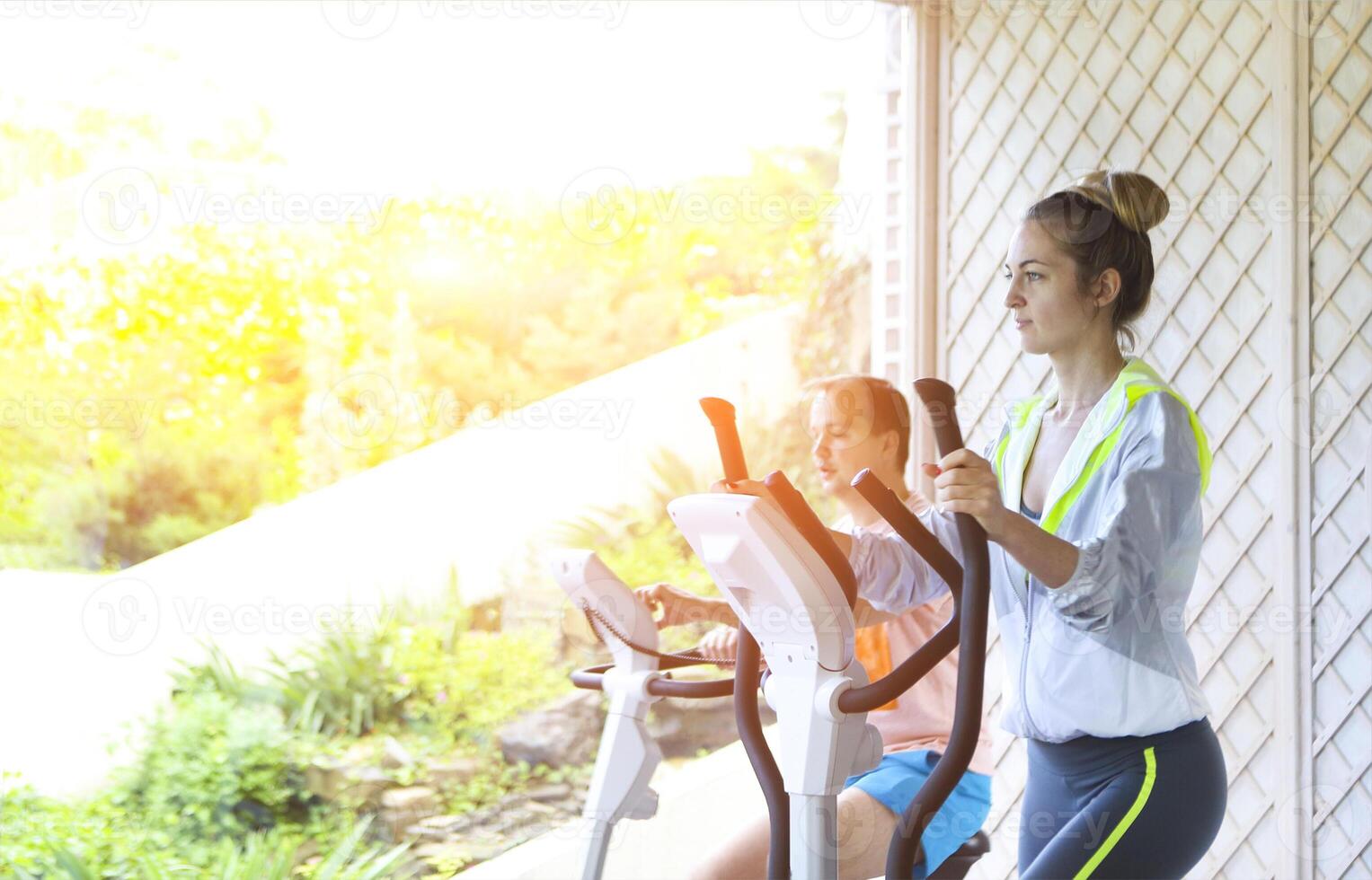 Couple training on a treadmill in a sport centre photo