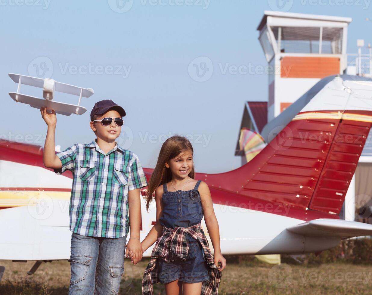 Little boy and little girl pilot with handmade plane photo