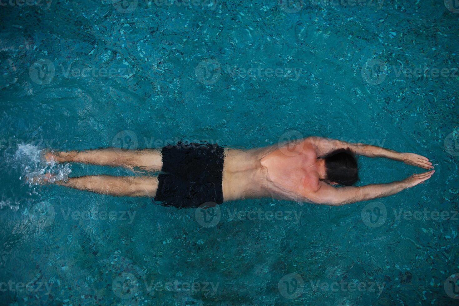 Athletic man swimming in the pool photo