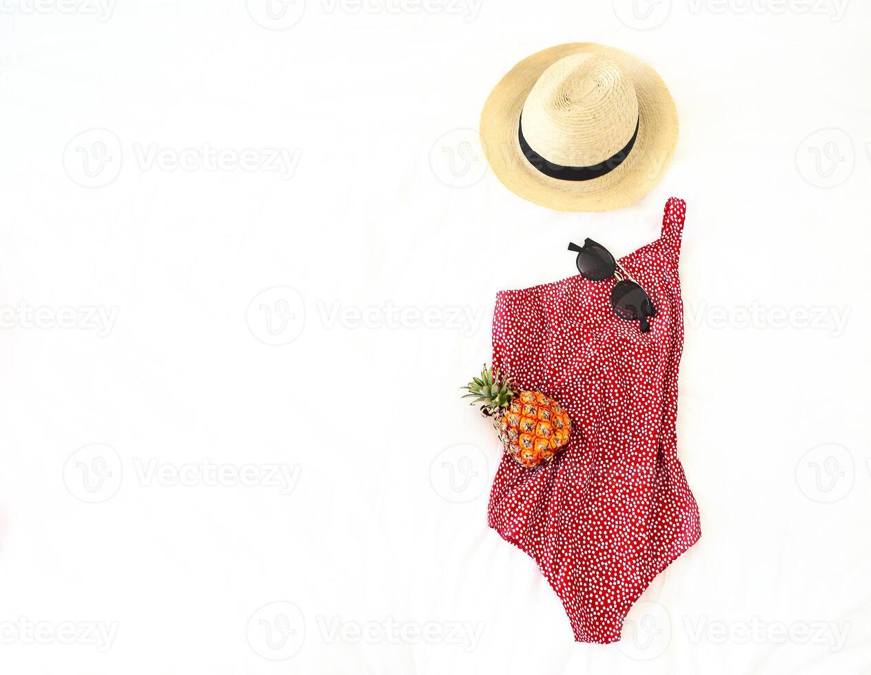 Summer vacation concept with swimwear sunglasses hat and pineapple photo