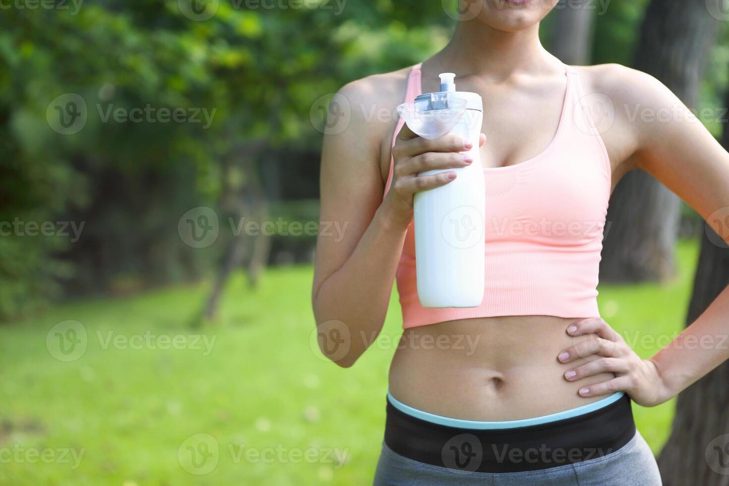 Fitness athlete woman resting drinking water photo