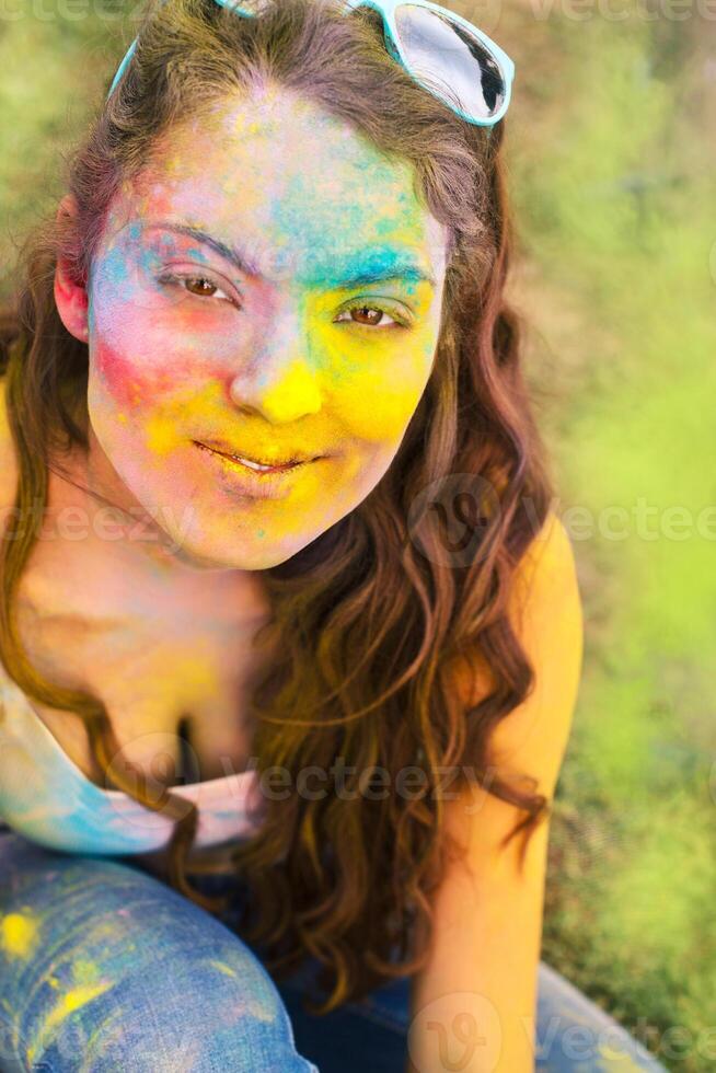 Happy young girl on holi color festival photo