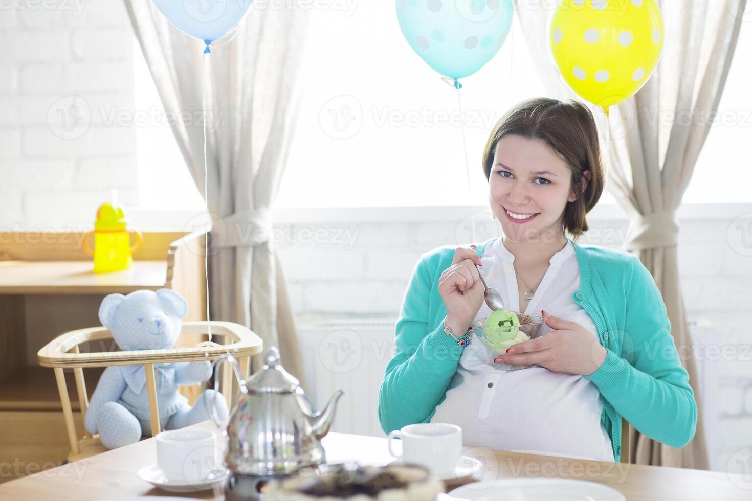 Happy pregnant woman with ice cream photo