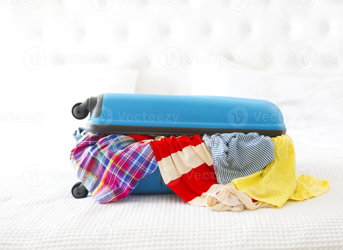 Clothes and accessories in turquoise suitcase photo