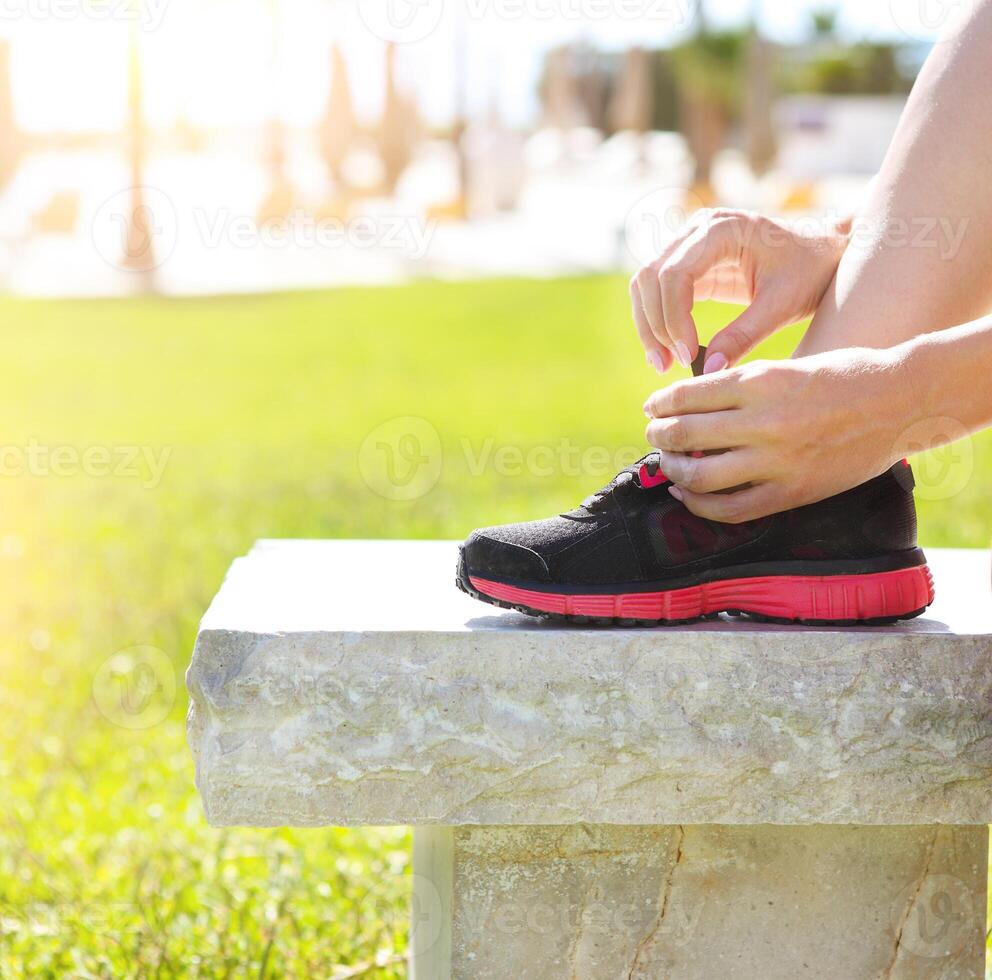 Athlete girl trying running shoes getting ready for jogging photo