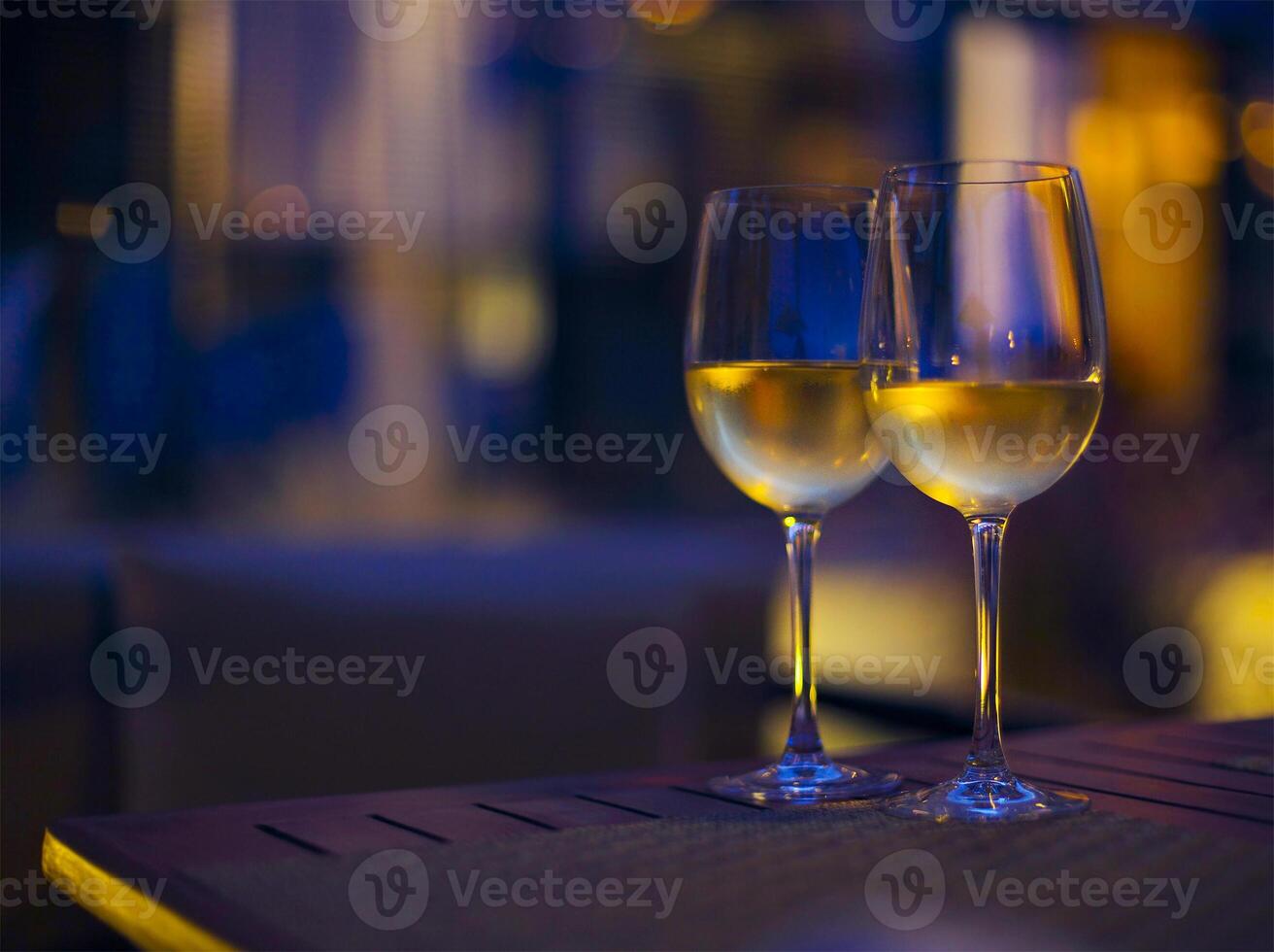 Two glasses of the white wine in the night photo
