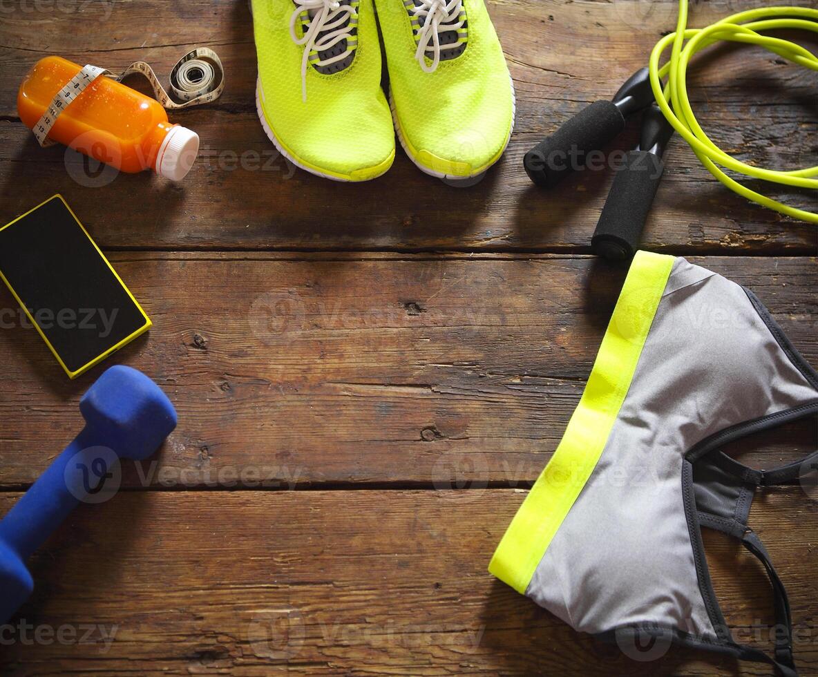 Female sport equipment on a wooden background photo