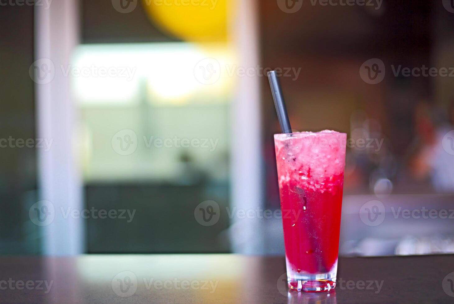Cocktail glass on bar counter in nightclub photo