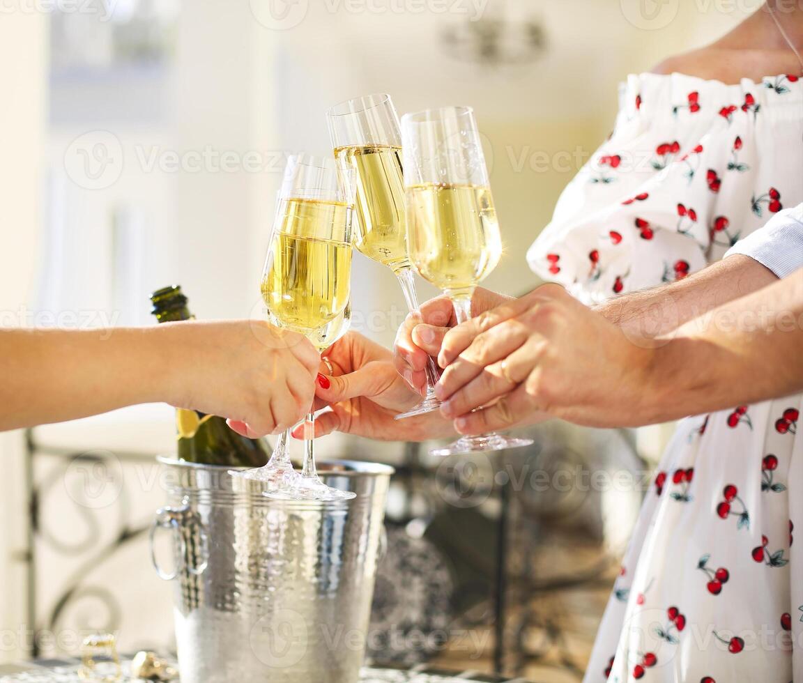 Friends making toast. Party with sparkling champagne glasses photo