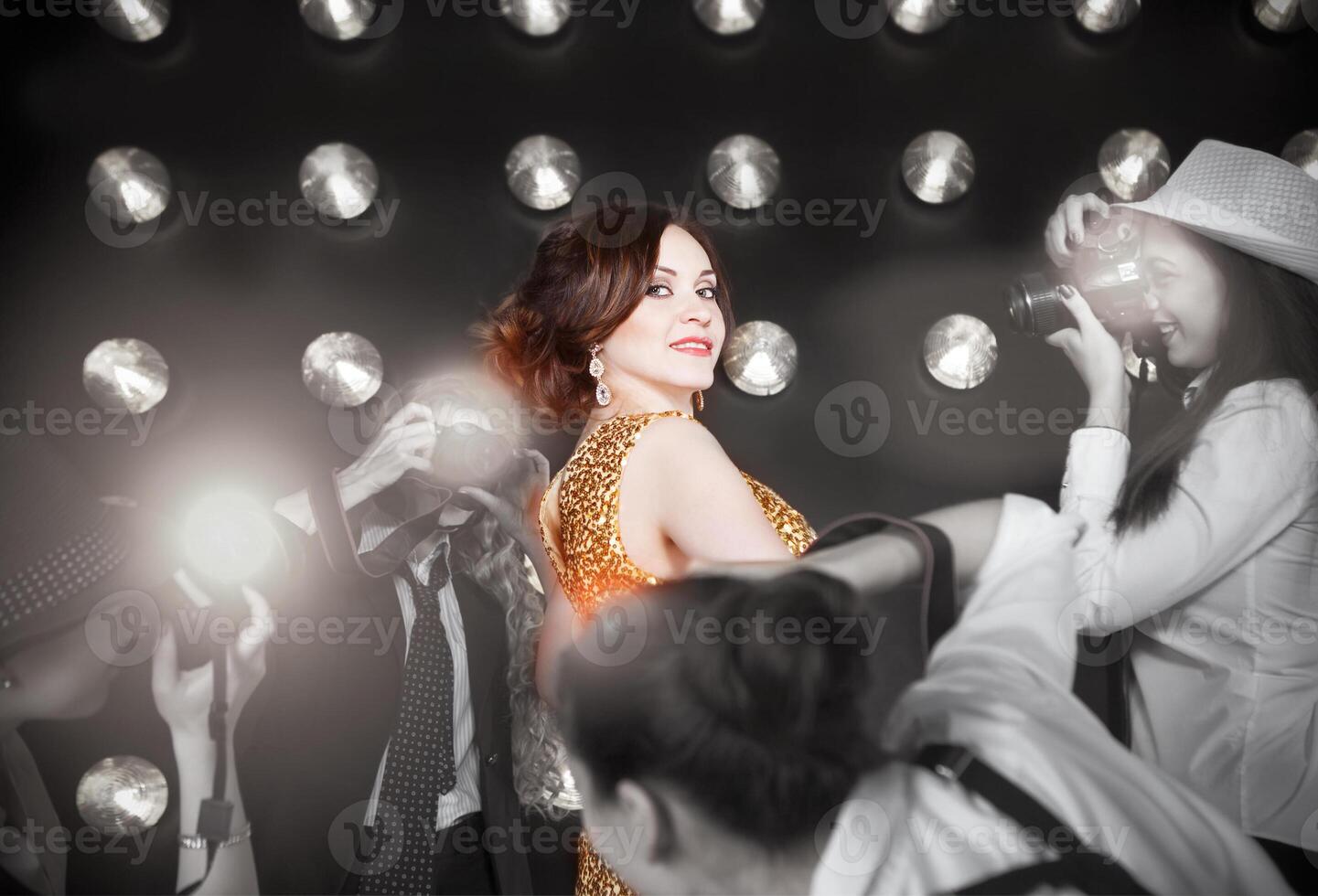 Superstar woman wearing golden shining dress photo