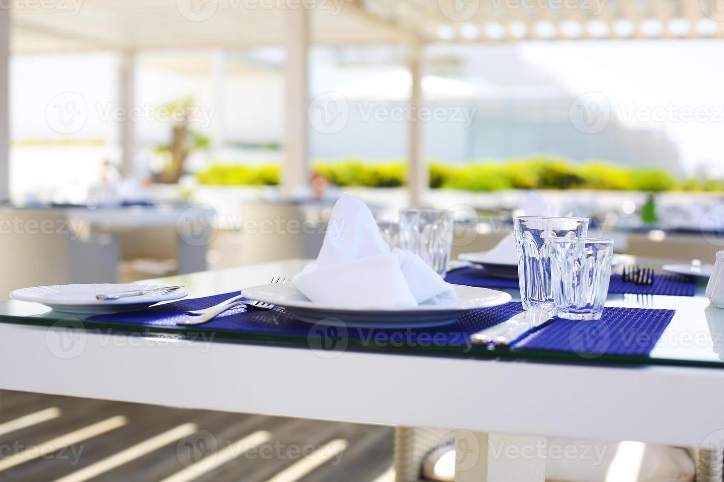 Glasses and plates on the tables photo