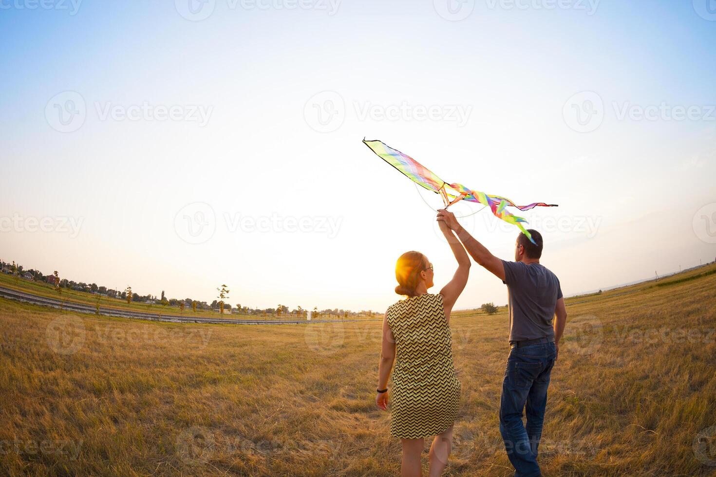 Happy couple in love with flying a kite photo