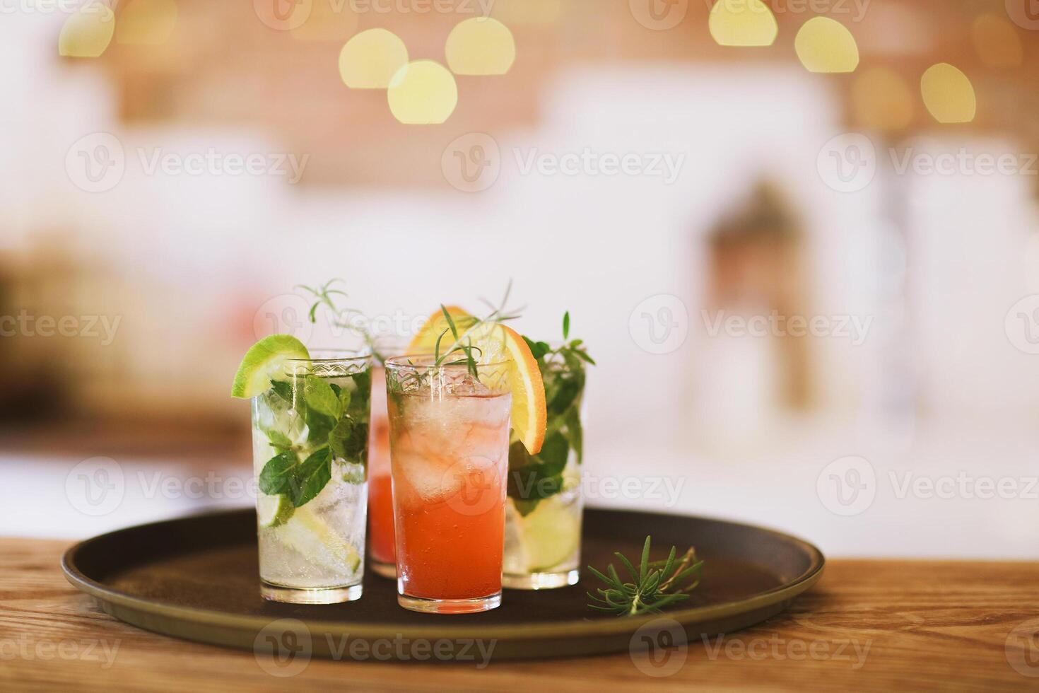 Two cocktail glasses on tray in the bar photo