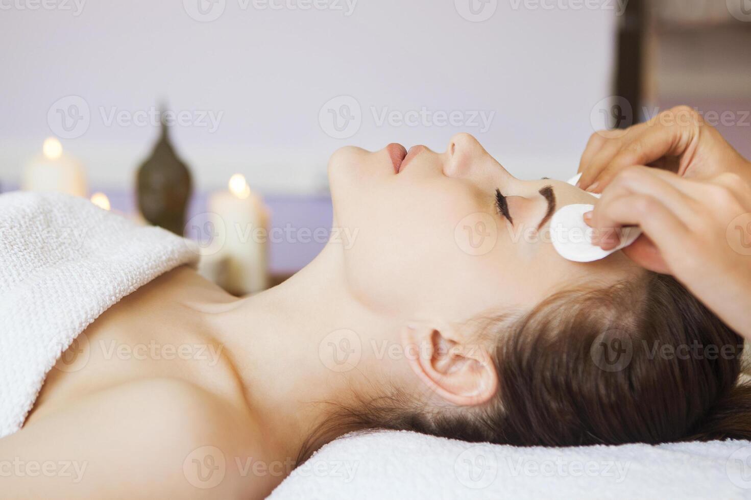 Relaxed woman with a deep cleansing nourishing face mask applied to her face photo