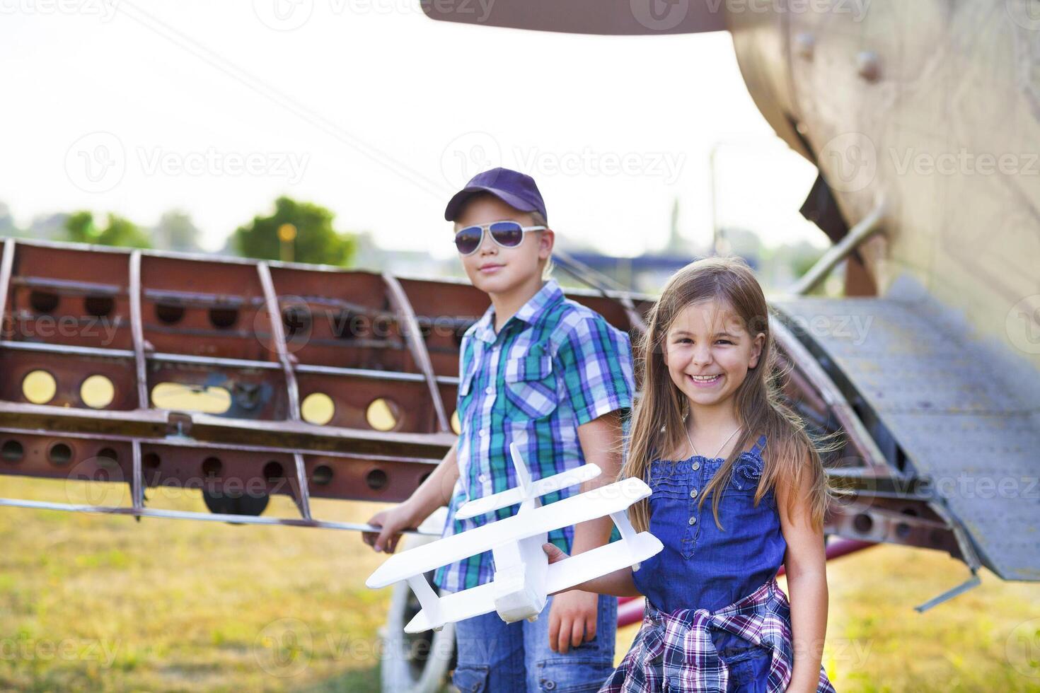 Little boy and little girl pilot with handmade plane photo