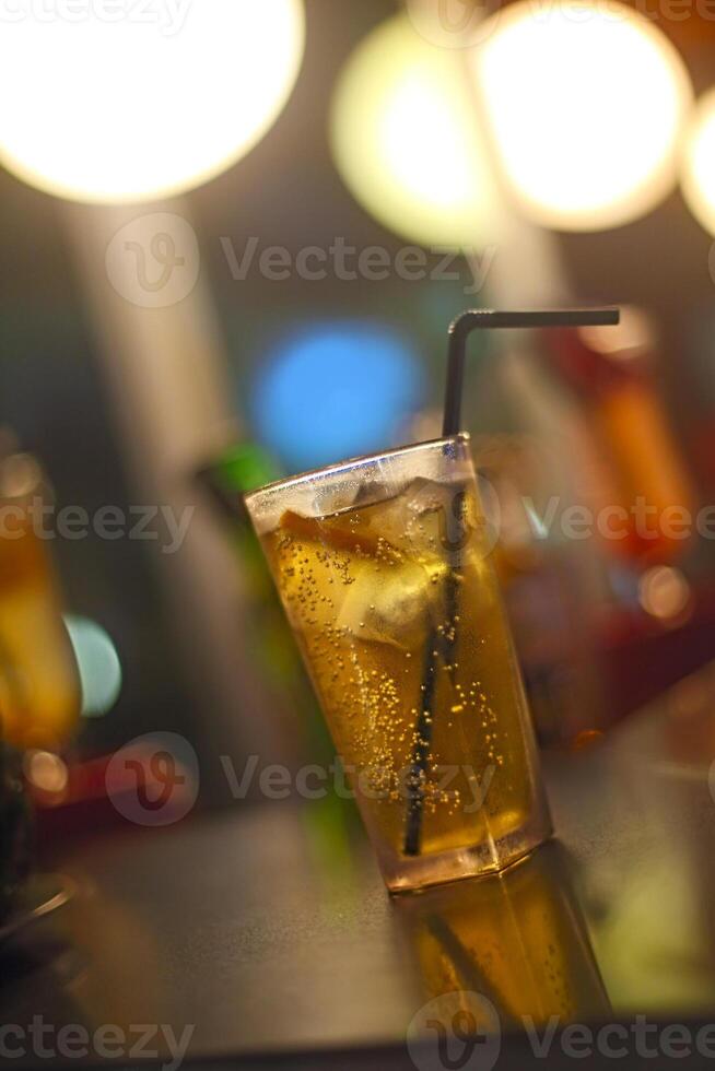 Cocktail glass on bar counter in nightclub photo